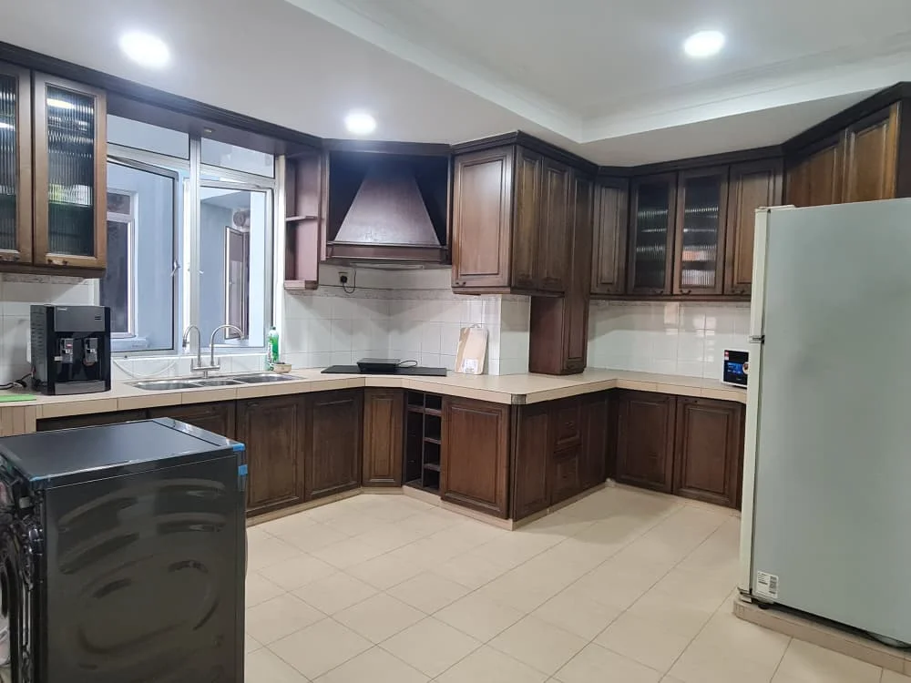 Kitchen features: brown wooden cabinetry, granite countertop, double-bowl stainless-steel sink, chrome pull-down faucet, built-in oven, freestanding range oven, stainless-steel fridge, black countertop appliance, tile backsplash, window above sink, recessed downlights, cream tiled flooring; style: traditional.